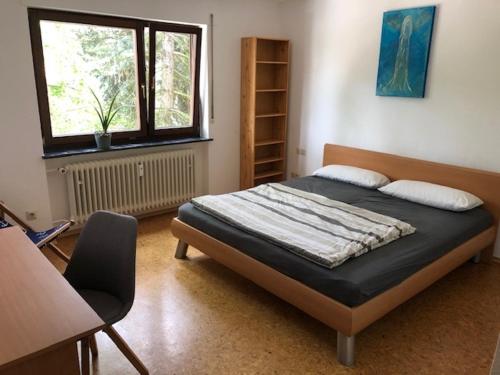 a bedroom with a bed and a window at Haus Schwarzwaldblick in Achern