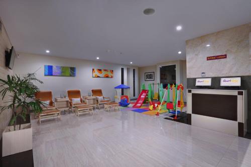 a waiting room with chairs and a play area at Quest San Denpasar by ASTON in Denpasar