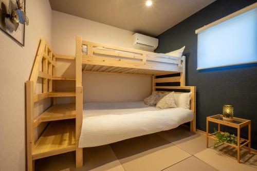 a bedroom with two bunk beds and a window at Sakura Moana - Vacation STAY 06385v in Fukaura