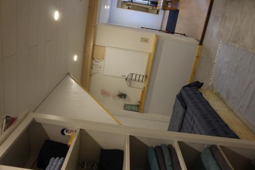 a small kitchen with a refrigerator in a room at Am Barthelwald in Wilhelmsdorf