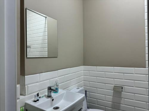 アルマトイにあるRiver Apartの洗面台、鏡、トイレ付きのバスルーム