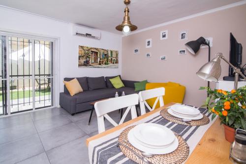 a living room with a couch and a table at HaBaitBe Matityahu By Domus in Beer Sheva