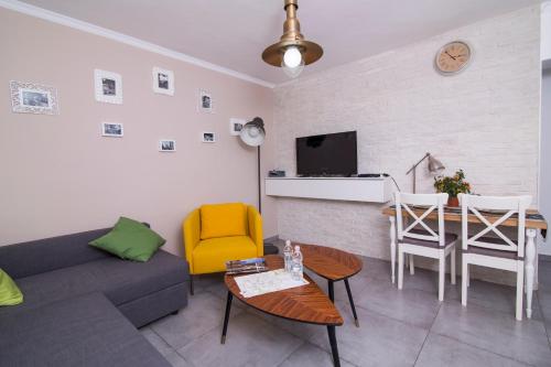 a living room with a couch and a table at HaBaitBe Matityahu By Domus in Beer Sheva