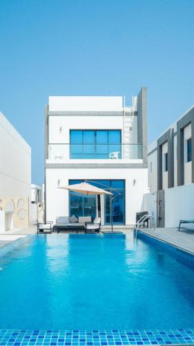 a house with a swimming pool in front of a building at 3BR villa and maid room by escape time in Sharm