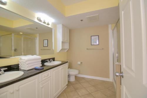a bathroom with two sinks and a toilet at Crescent Shores South - 108 in Myrtle Beach
