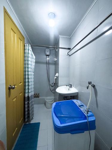 a bathroom with a toilet and a sink at Modern 2BR Escape Overlooking the Iloilo River in Mandurriao