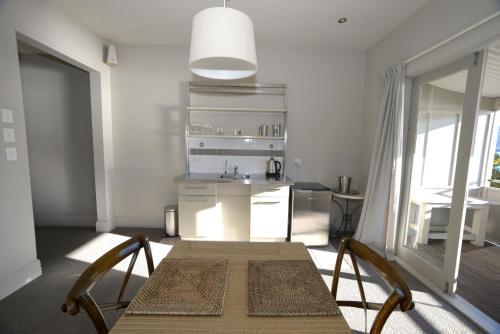 a kitchen with a table and chairs in a room at Akaroa Village Inn in Akaroa