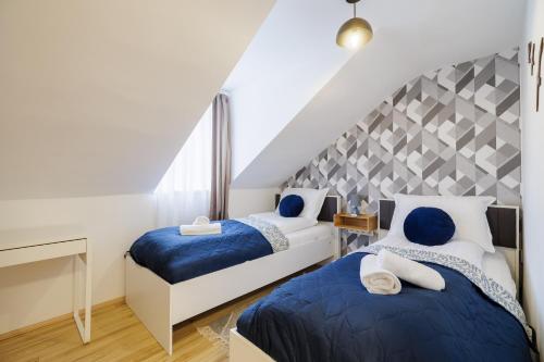 Ένα ή περισσότερα κρεβάτια σε δωμάτιο στο Deluxe Design Apartman