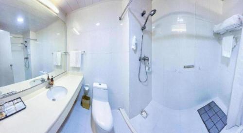 a white bathroom with a shower and a sink at Super8 Hotel Anyang Hongqi Road in Anyang