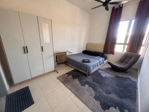 a bedroom with a bed and a chair in it at MAHEER HOMESTAY Puncak Alam in Bandar Puncak Alam