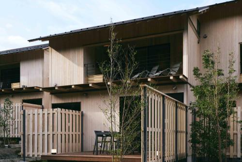 a house with a wooden deck and a balcony at GEOSPOT Motohakone A 2025年10月 New Open in Hakone