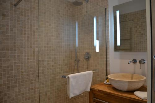 a bathroom with a sink and a glass shower at Villa Le Sud in Cassis