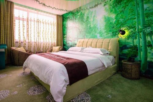 a bedroom with a large bed with a green wall at James Joyce Coffetel Tianjin Railway Station Jinshiqiao Metro Station Branch in Tianjin