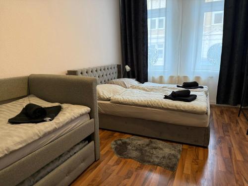 a bedroom with two beds and a couch at Eigentumswohnung in Dresden in Dresden