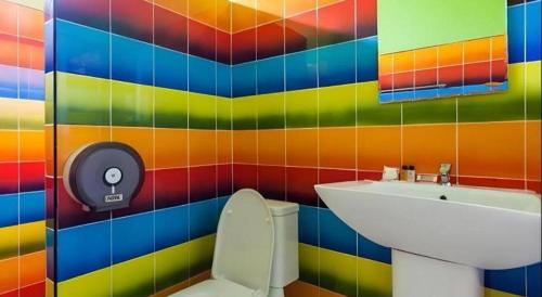 a colorful bathroom with a toilet and a sink at Sixty-nine Resort in Ban Tha Khwai