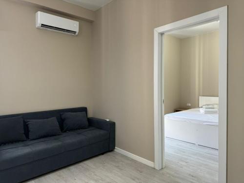 アルマトイにあるRiver Apartのソファとベッドのあるリビングルーム