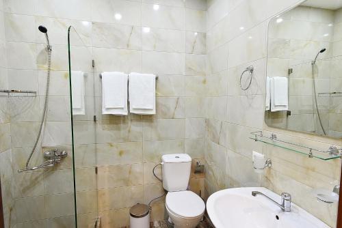 y baño con aseo, lavabo y ducha. en MGK Hotel en Tiflis
