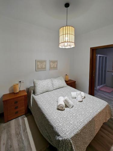 a bedroom with a bed with two towels on it at Villa Bellavista in Olvera