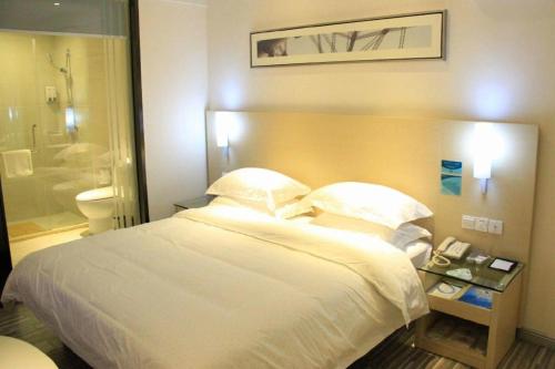 HepuにあるCity Comfort Inn Beihai Hepu Bus Terminalのベッドとバスルームがあるホテルの部屋