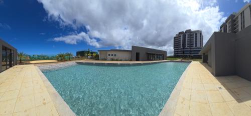 a large swimming pool in front of a building at Elandor Suite East Minissy Moka in Moka