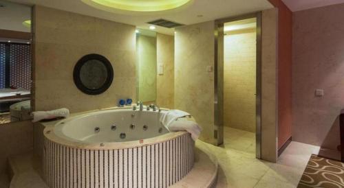 a large bathroom with a large tub in a room at The Qube Shanghai Nanqiao in Fengxian