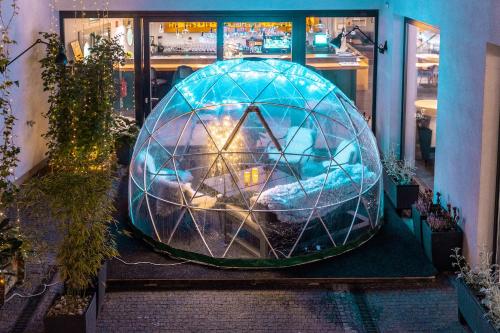 a large glass dome sitting inside of a building at INNSiDE by Meliá Prague Old Town in Prague
