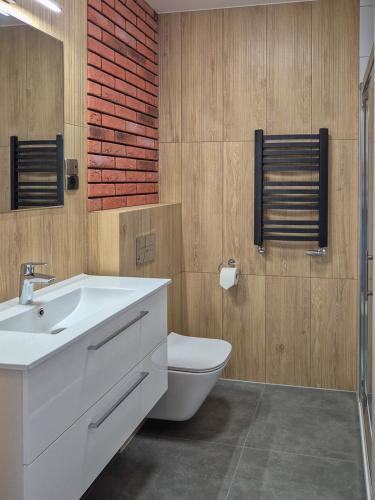 a bathroom with a white sink and a toilet at Hotel Topaz Poznań Centrum in Poznań