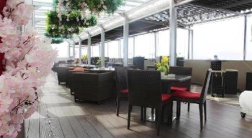 ソロンにあるThe Belagri Hotel and Conventionのピンクの花が飾られたダイニングルーム(テーブル、椅子付)