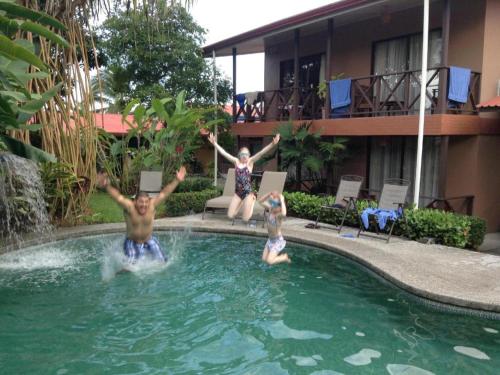 a couple of people in a swimming pool at Hotel Bijagua in Fortuna