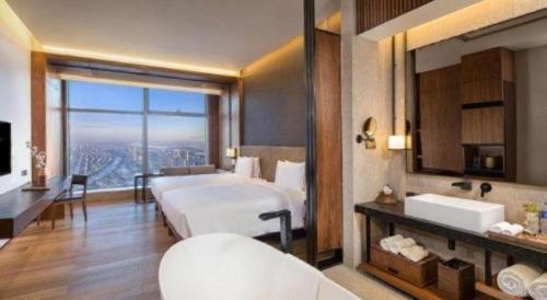 a bedroom with a large bed and a large window at AOLUGUYA in Harbin