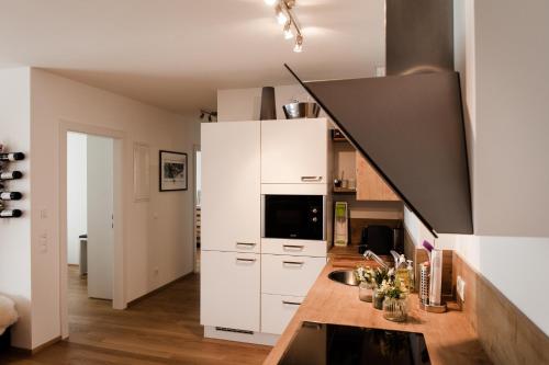 a kitchen with white cabinets and a counter top at Appartement Hauser Kaibling in Haus im Ennstal