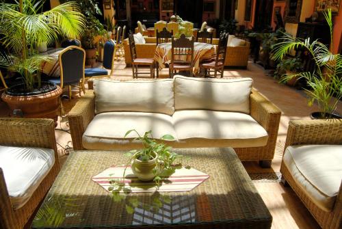 a living room with a couch and a table at Hotel Pinomar in El Puerto de Santa María