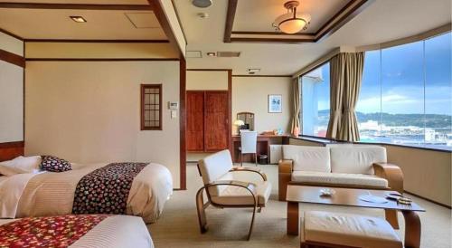 a hotel room with two beds and a living room at Otaru Furukawa Hotel in Kita-hamachō