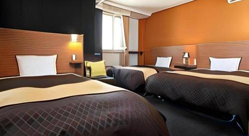 Postel nebo postele na pokoji v ubytování Hotel 1-2-3 Kofu Shingen Onsen