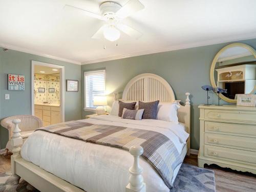 a bedroom with a bed and a dresser and a mirror at Stay-A-While in Tybee Island