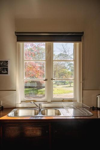 a kitchen sink in front of a window at Fairbridge Village in Pinjarra