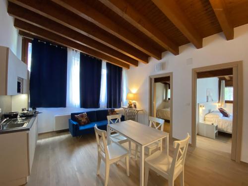 a living room with a table and a blue couch at International Residence in Tarvisio