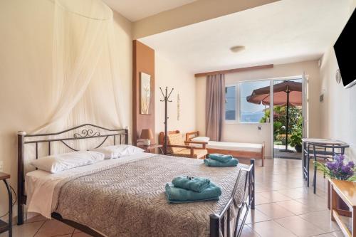 a bedroom with a bed with two towels on it at Christianna studios in Nikiana