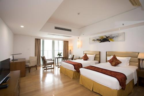 Ένα ή περισσότερα κρεβάτια σε δωμάτιο στο Guangzhou Xiangxue International Apartment