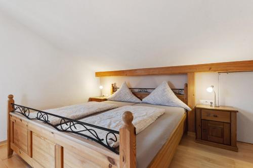 a bedroom with a large bed with a wooden frame at Weingut Ringwald in Herbolzheim
