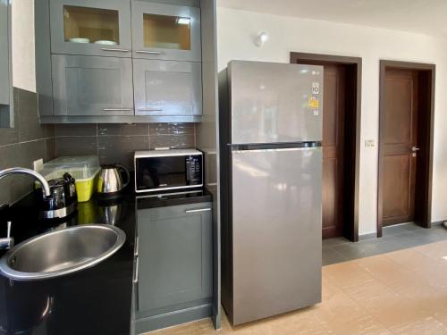 a kitchen with a stainless steel refrigerator and a sink at Urai Villa by Utalay Koh Chang in Ban Khlong Son