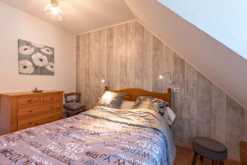 ルダンヴィエルにあるGite Clarabideのベッドと木の壁がある寝室