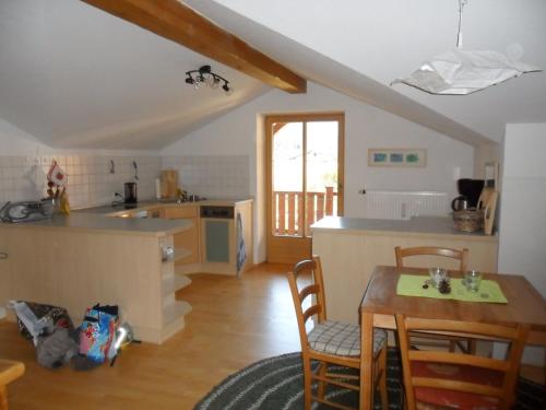 a kitchen with a table and a table and chairs at Alpenpanorama vacation home in Bergen
