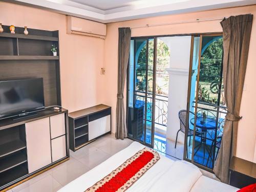 a living room with a couch and a balcony at House Of Pattaya- Near Walking Street in Pattaya South