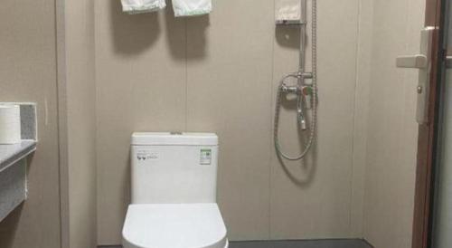 a bathroom with a shower and a toilet in it at GreenTree Inn Laiwu Frank in Zhaizi