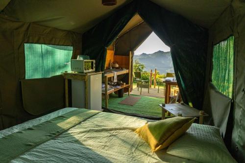 a bedroom with a bed in a tent at Safari Glamping Portugal Elephant in Ventosa