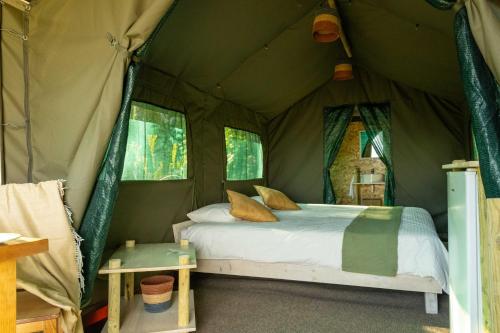 a bedroom with a bed in a tent at Safari Glamping Portugal Elephant in Ventosa