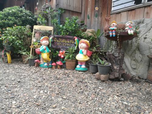 a group of garden figurines sitting next to a sign at Ever Green Guest House - SHA Plus in Pai