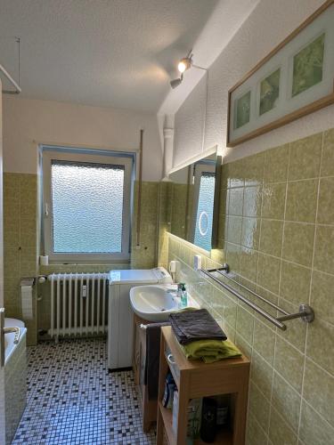 a bathroom with a sink and a toilet and a window at Living Lu - cosy Apartment two - Netflix - Mannheim - BASF - 2 Zimmer in Ludwigshafen am Rhein