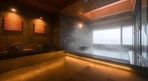 a bathroom with a bath tub and a window at KEIKYU EX INN Haneda Innovation City 2 minutes walk from HICity Exit of Tenkubashi Station in Tokyo